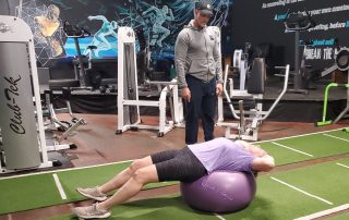 Michael Cornell, male personal trainer works with female personal training client using stability ball